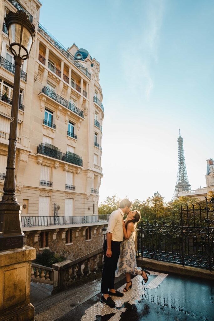 Couple kissing on a street in Paris near Eiffel Tower Couple kissing outdoors on a Parisian street with the Eiffel Tower in the background.