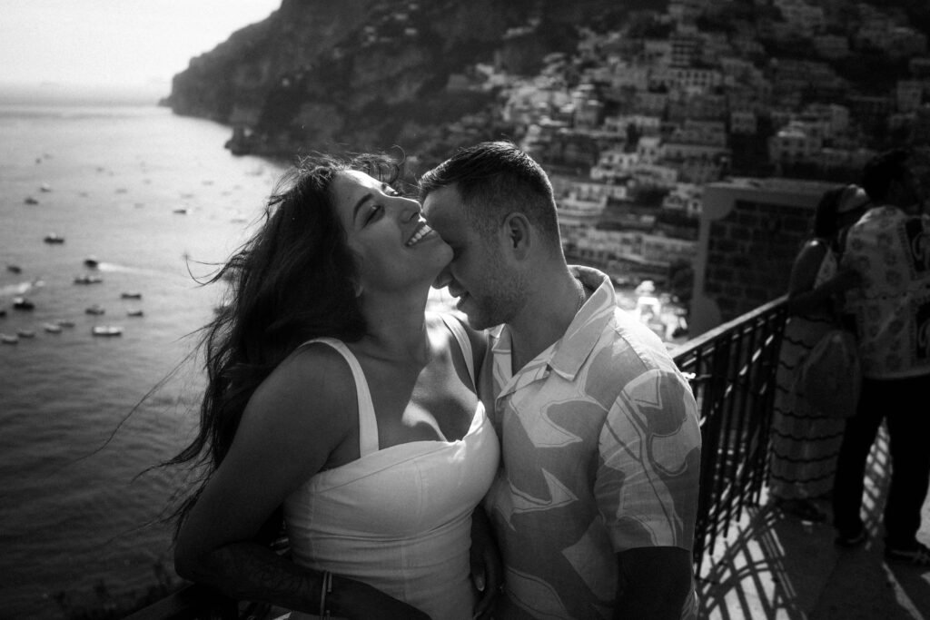 Couple embracing on a terrace overlooking Positano Couple embracing on a terrace overlooking the coast and sea in Positano
